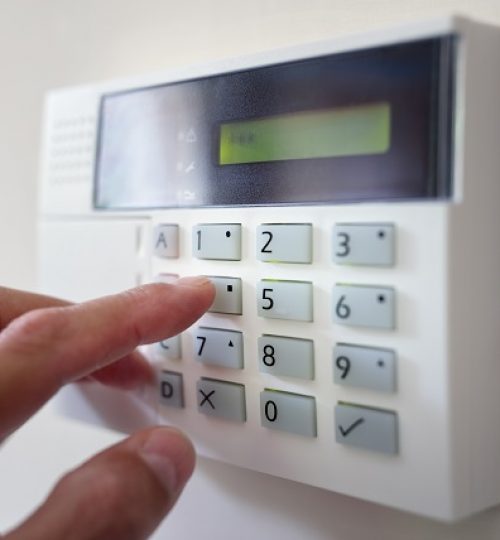 Security alarm keypad with person arming the system concept for crime prevention